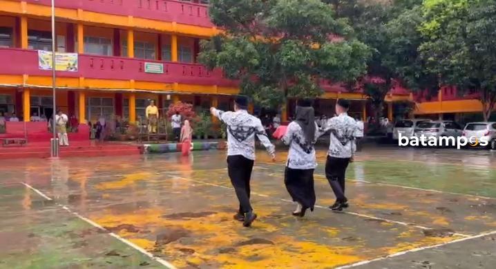 Upacara Haru di Tengah Hujan, SMKN 2 Batam Apresiasi Guru Berprestasi